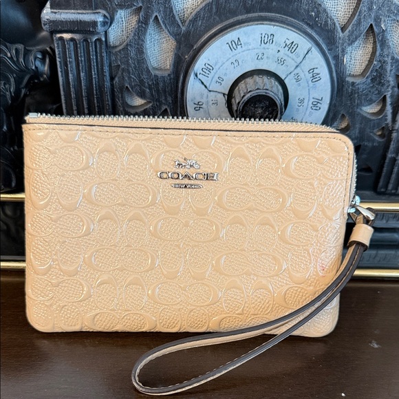 Coach Handbags - Coach Beige single zip Signature Embossed Wristlet wallet